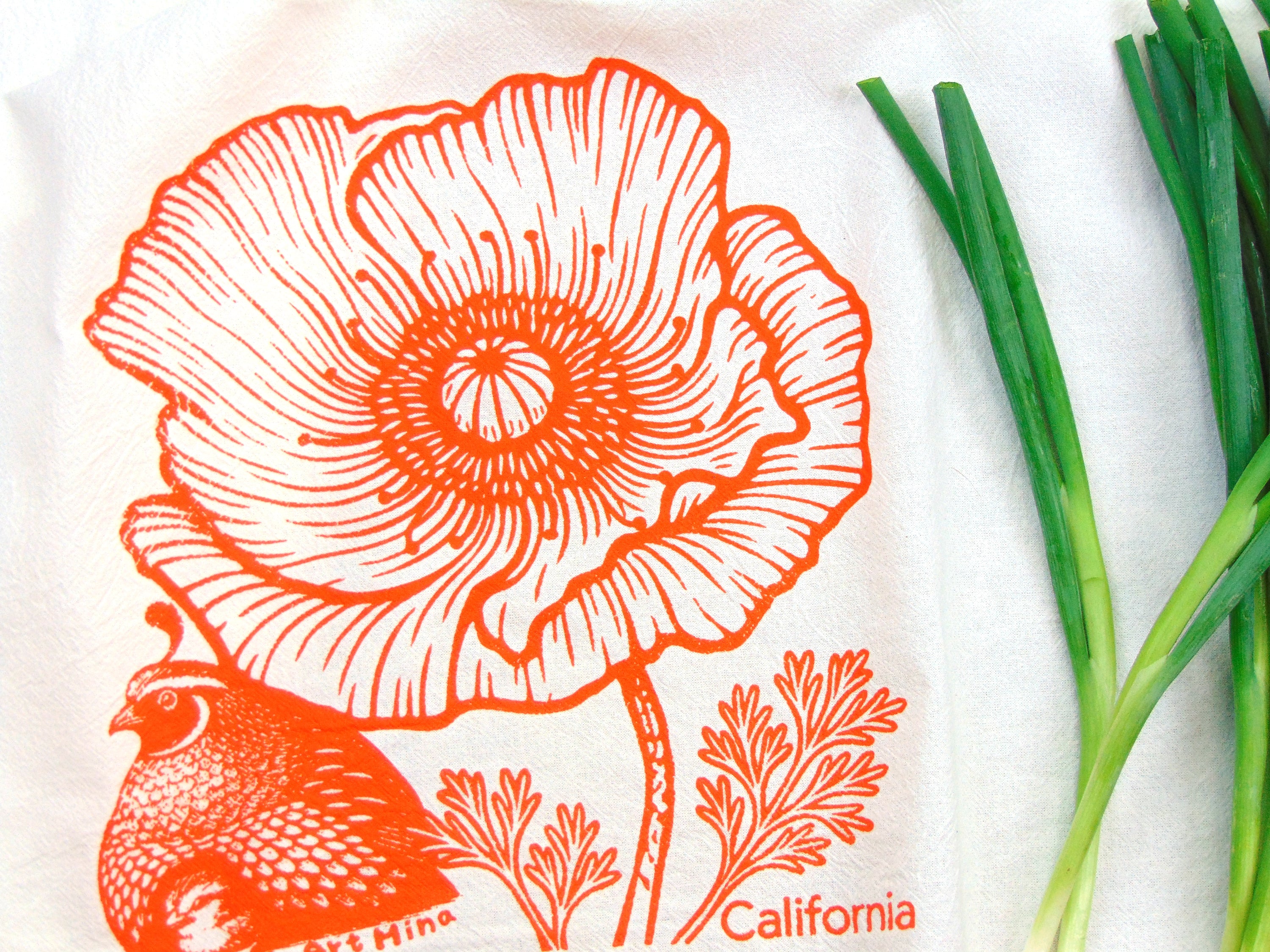 Screen-printed California poppy and quail in orange on a white cotton flour sack towel.